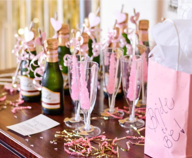 Bachelorette party table with champagne and pink decor