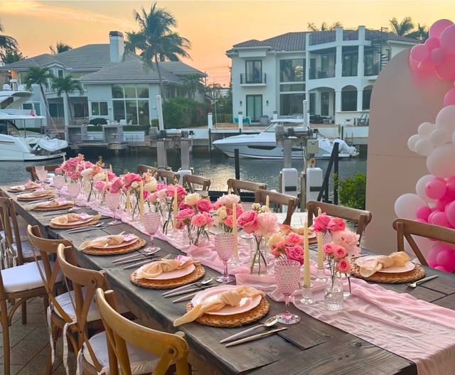 Dinner party table set beside the water